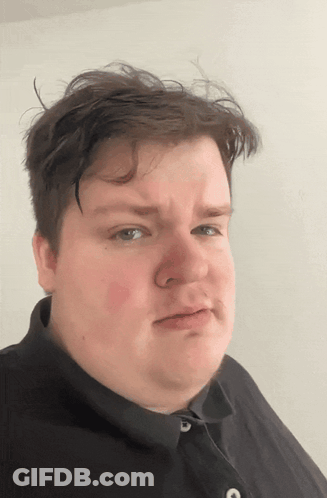 A Man In A Black Shirt Is Making A Face GIF