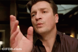 A Man In A Black Shirt Is Making A Funny Face And Pointing His Finger . GIF
