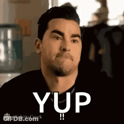 A Man In A Black Shirt Is Making A Funny Face And Says Yup . GIF