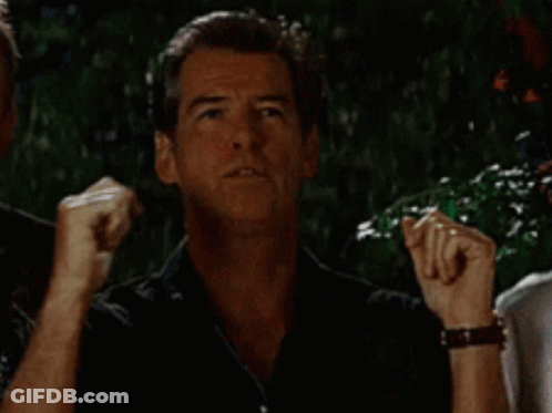 A Man In A Black Shirt Is Making A Funny Face While Standing Next To Another Man . GIF