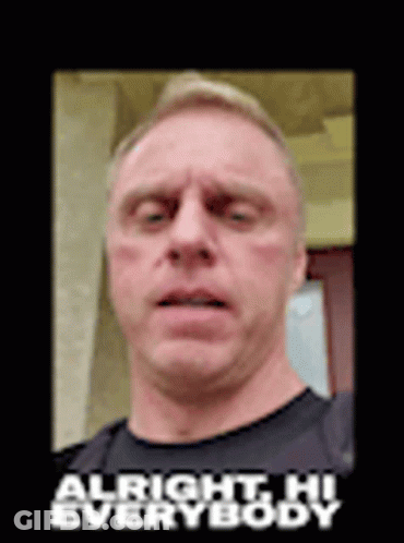 A Man In A Black Shirt Is Making A Funny Face With The Words `` Alright Hi Everybody '' Above Him . GIF