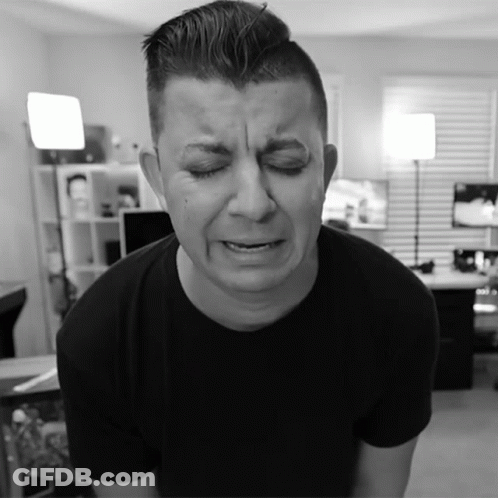 A Man In A Black Shirt Is Making A Sad Face With His Eyes Closed GIF