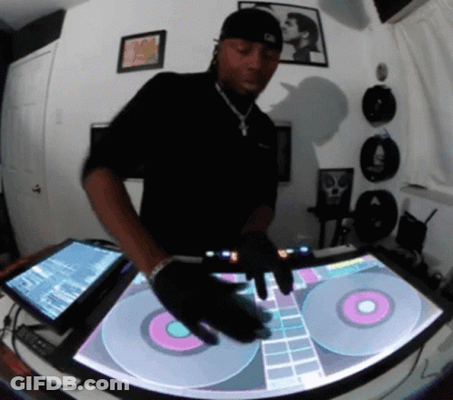 A Man In A Black Shirt Is Playing Music On A Turntable GIF
