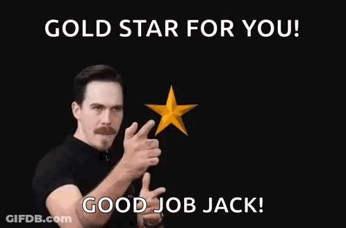 A Man In A Black Shirt Is Pointing At Two Gold Stars With His Fingers . GIF