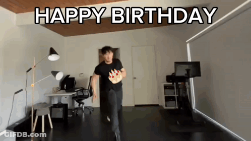 A Man In A Black Shirt Is Running With A Birthday Cake In His Hand And The Words Happy Birthday Behind Him GIF