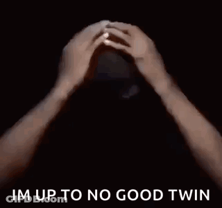 A Man In A Black Shirt Is Saying `` Im Up To No Good Twin '' In A Dark Room . GIF