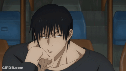 A Man In A Black Shirt Is Sitting In A Chair GIF