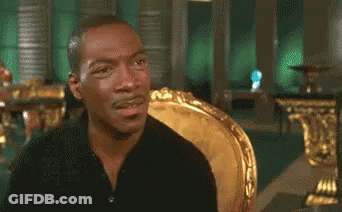 Man In Black Shirt Sitting In Gold Chair GIF
