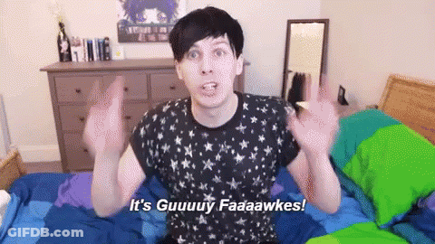 A Man In A Black Shirt Is Sitting On A Bed And Says It 'S Guuuy Faaaawkes GIF