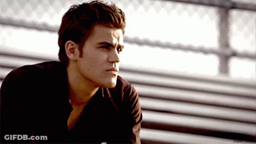 A Man In A Black Shirt Is Sitting On A Bench With His Eyes Closed . GIF