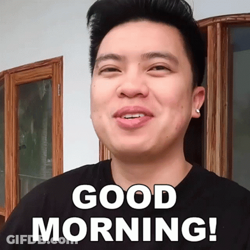 A Man In A Black Shirt Is Smiling And Says Good Morning GIF