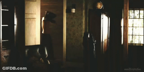 A Man In A Black Shirt Is Standing In A Dark Room With The Words Madforeststefan Written On The Bottom GIF
