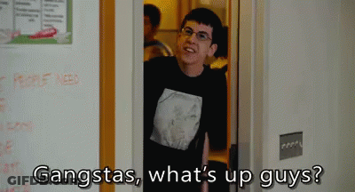 A Man In A Black Shirt Is Standing In A Doorway And Says Gangstas What 'S Up Guys ? GIF