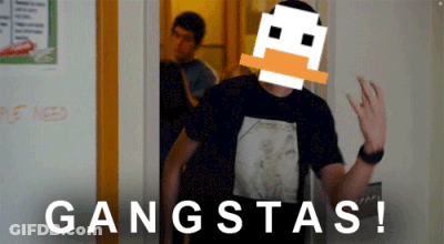 A Man In A Black Shirt Is Standing In Front Of A Door That Says Gangstas On It GIF