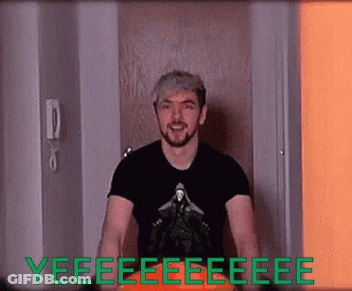 A Man In A Black Shirt Is Standing In Front Of A Door That Says Yeee GIF