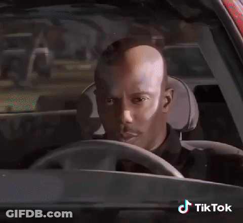 A Man In A Black Shirt Is Standing In Front Of A Police Officer .. GIF