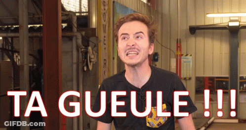 A Man In A Black Shirt Is Standing In Front Of A Sign That Says Ta Gueule GIF
