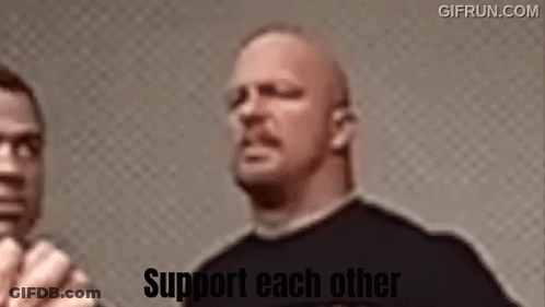 A Man In A Black Shirt Is Standing Next To Another Man With The Words Support Each Other On The Bottom . GIF