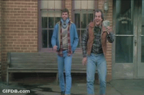 A Man In A Black Shirt Is Standing Next To Another Man GIF