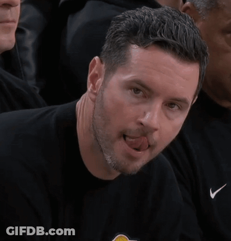 A Man In A Black Shirt Is Sticking His Tongue Out . GIF