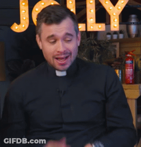 A Man In A Black Shirt Is Talking In Front Of A Sign That Says Jolly GIF