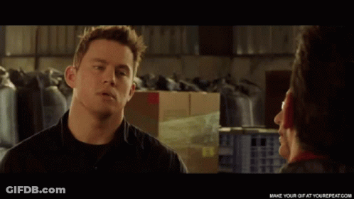 A Man In A Black Shirt Is Talking To A Woman GIF