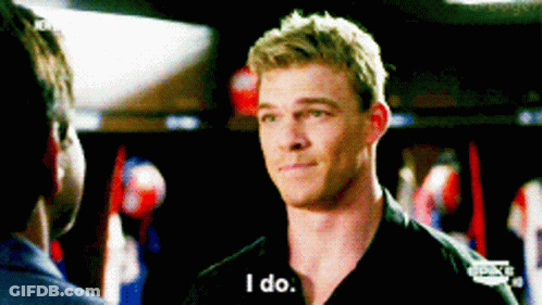 A Man In A Black Shirt Is Talking To Another Man And Says I Do GIF