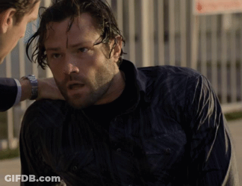 A Man In A Black Shirt Is Talking To Another Man GIF