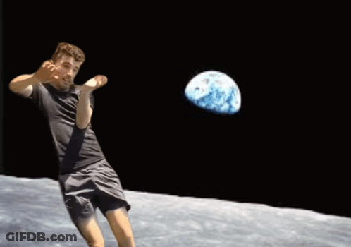 A Man In A Black Shirt Is Throwing A Ball With A Globe In The Background GIF
