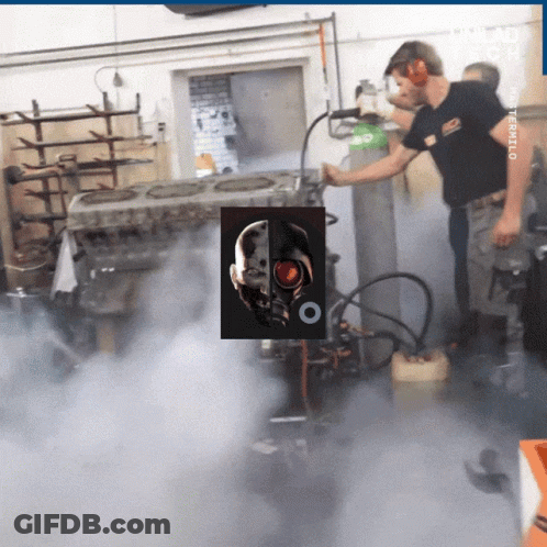 A Man In A Black Shirt Is Working On A Machine With A Picture Of A Terminator On It GIF