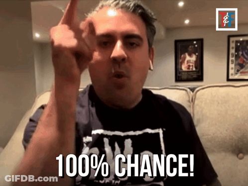 A Man In A Black Shirt Says 100 % Chance In Front Of A Couch GIF