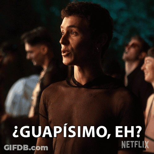 A Man In A Black Shirt Says " Guapisimo Eh " In Front Of A Crowd GIF