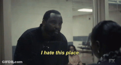 A Man In A Black Shirt Says I Hate This Place In Yellow Letters GIF