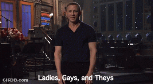 A Man In A Black Shirt Says Ladies Gays And Theys In Front Of A Stage GIF
