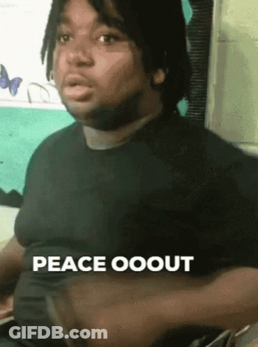A Man In A Black Shirt Says Peace Ooout With His Hands On His Chest . GIF