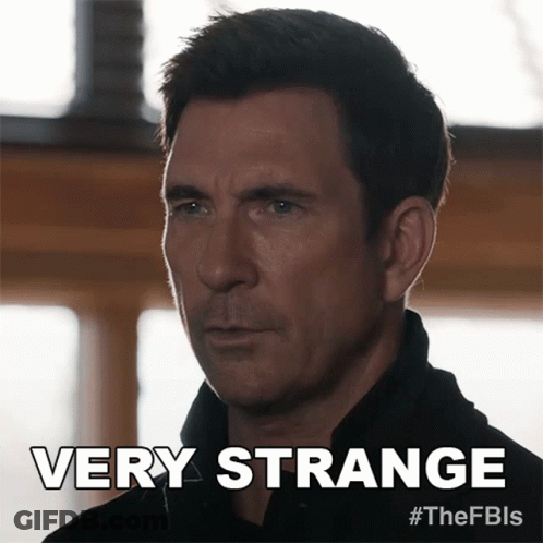 A Man In A Black Shirt Says Very Strange On The Bottom GIF