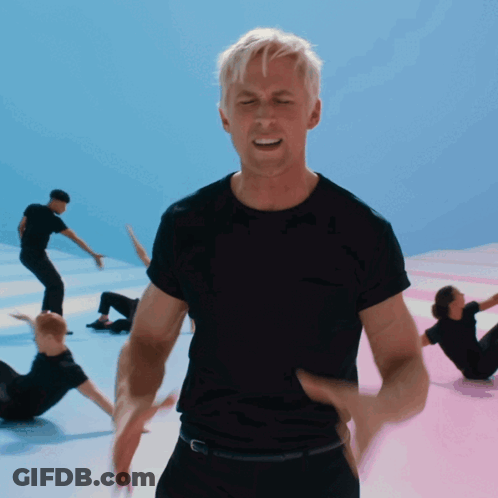A Man In A Black Shirt Stands In Front Of A Group Of People GIF