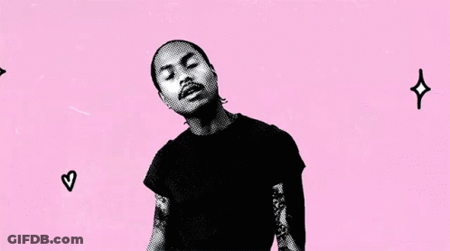 A Man In A Black Shirt Stands In Front Of A Pink Background That Says Some Times I Love You Too GIF