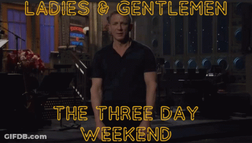 A Man In A Black Shirt Stands In Front Of A Sign That Says Ladies & Gentlemen GIF