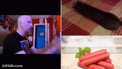 A Man In A Black Shirt Stands Next To A Pile Of Hot Dogs GIF