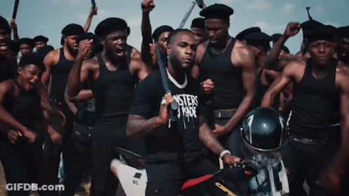 A Man In A Black Shirt That Says Misters Fade Is Holding A Bat GIF