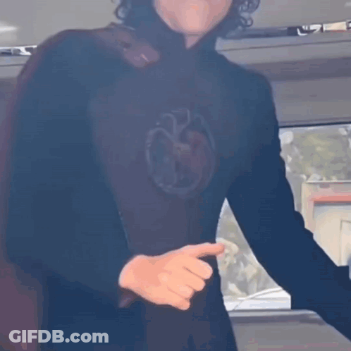 A Man In A Black Shirt With A Dragon On It GIF