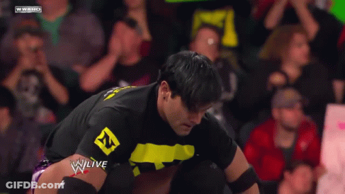 A Man In A Black Shirt With A Yellow Letter N On It GIF