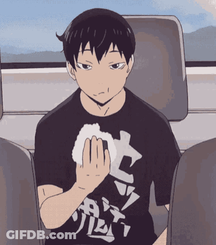 A Man In A Black Shirt With Chinese Writing On It GIF