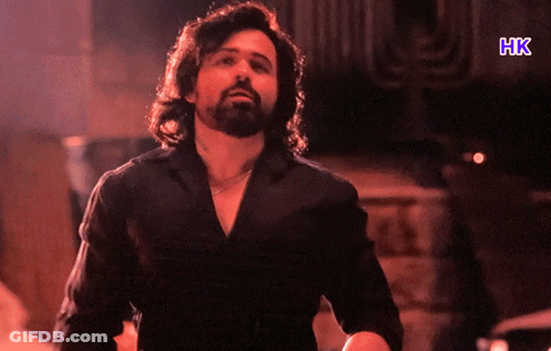 A Man In A Black Shirt With The Letters Hk On The Bottom GIF