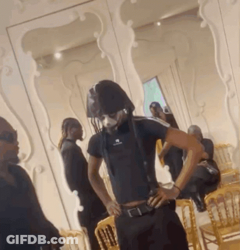 A Man In A Black Shirt With The Word Balenciaga On The Front GIF