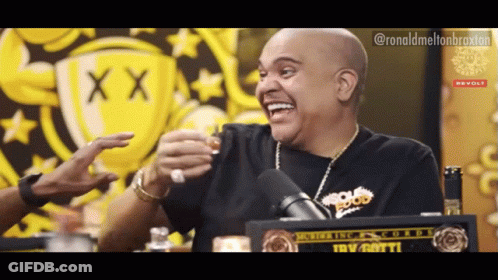 A Man In A Black Shirt With The Word Food On It Laughs GIF
