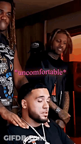 A Man In A Black Shirt With The Word Uncomfortable On The Bottom Right GIF