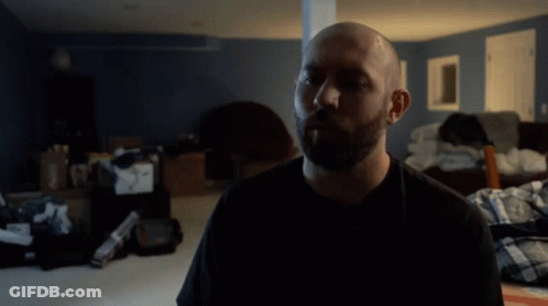 A Man In A Black Shirt With The Word Water Behind Him GIF