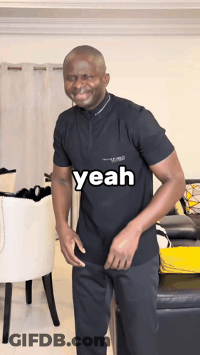 A Man In A Black Shirt With The Word Yeah On It GIF